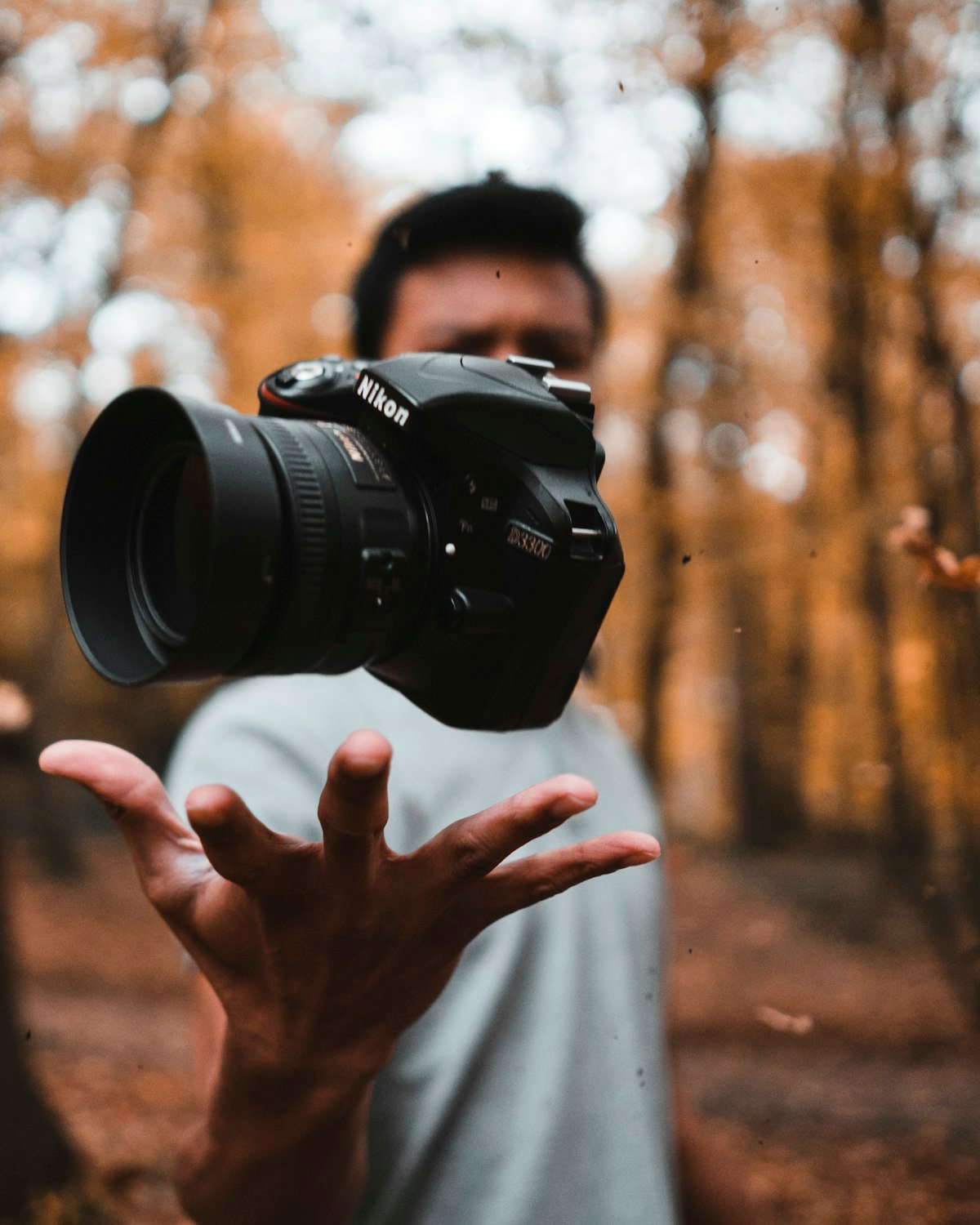Photographer holding a camera out towards the viewer