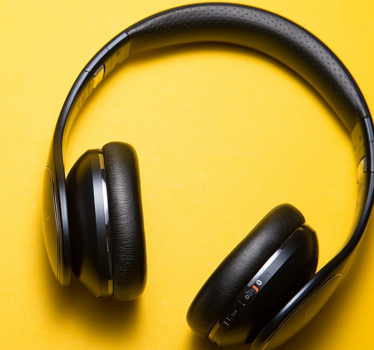 Black headphones on a bright yellow background
