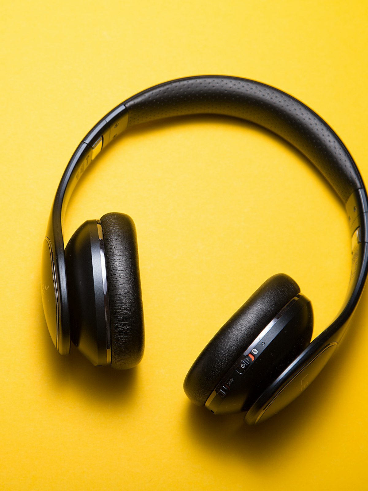 Black headphones on a bright yellow background