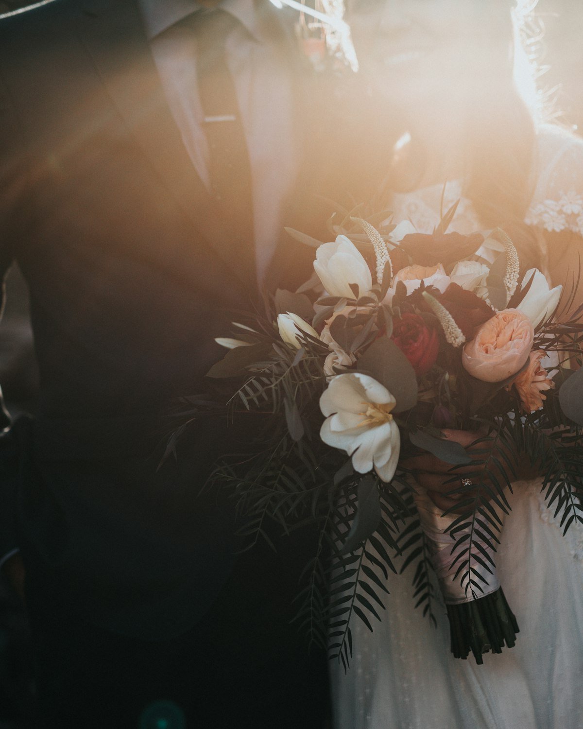 Bride holding a bouquet in soft evening light