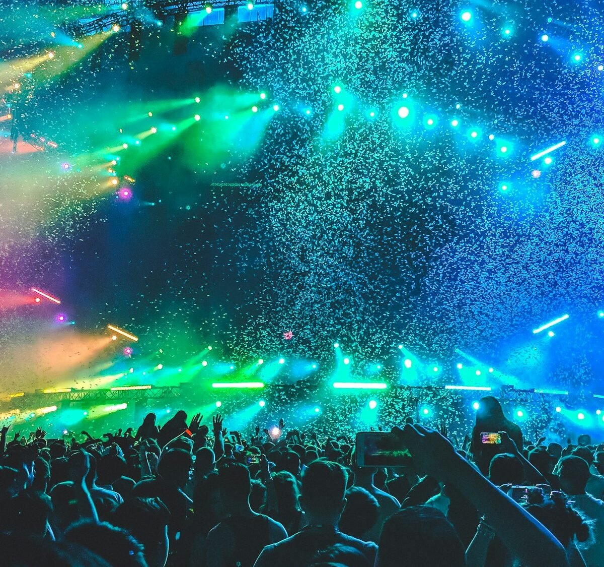 Concert crowd under colourful stage lights