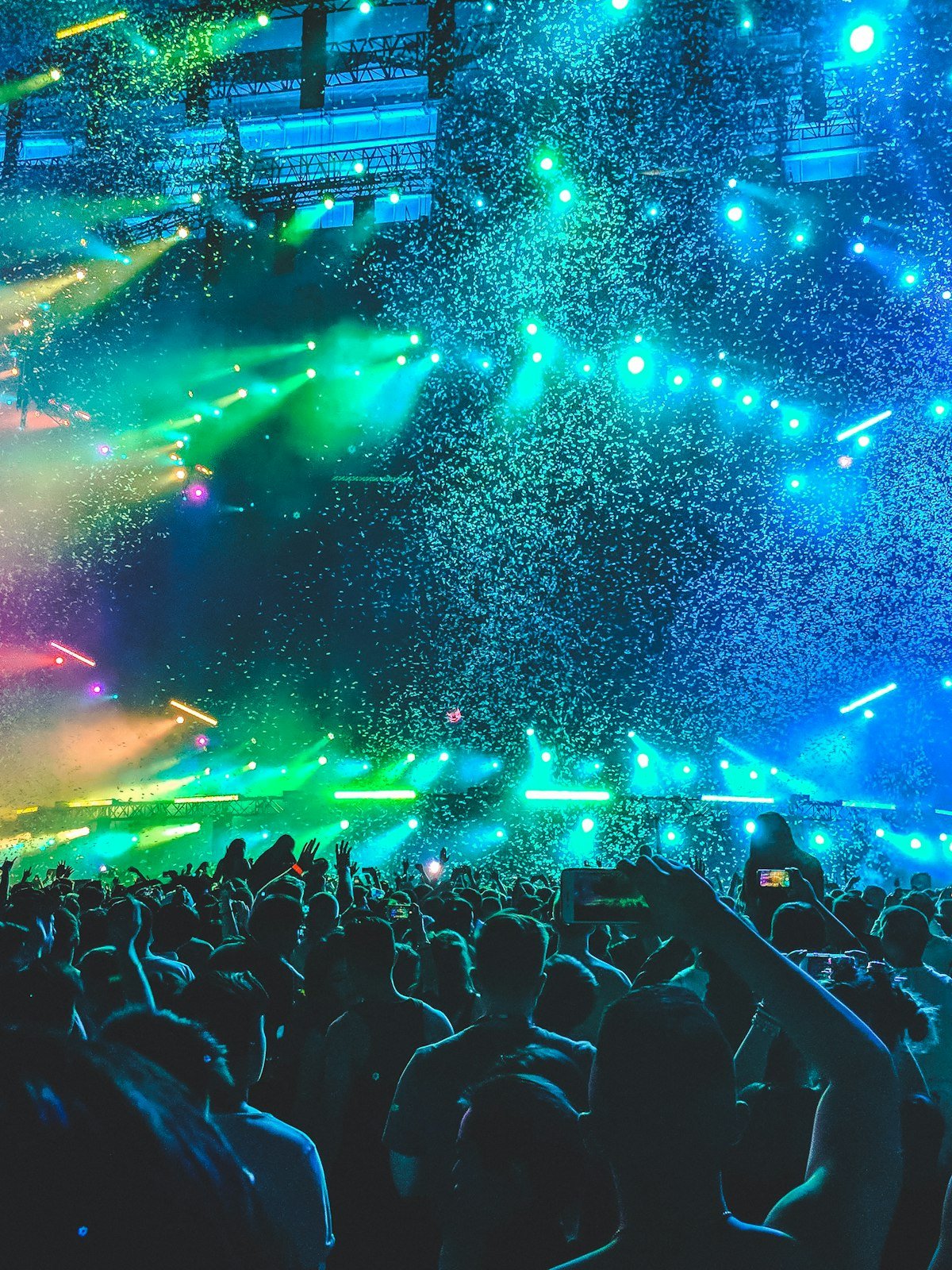 Concert crowd under colourful stage lights