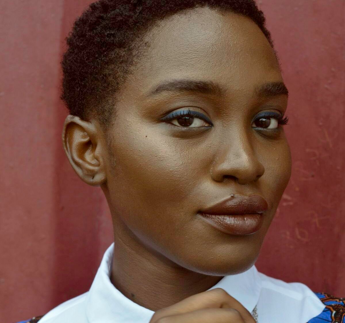 Close-up portrait of a woman in a white collar